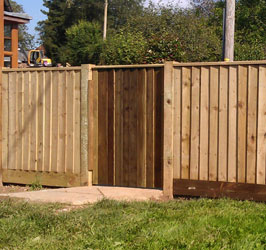 A tall timber fence with a matching gate section
