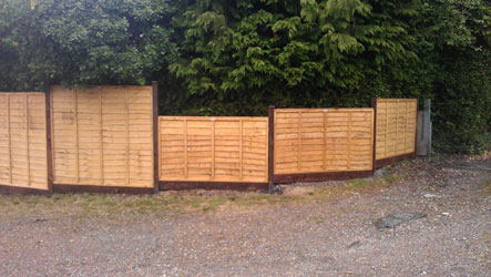 New panels along a gravel driveway with a Panda Fencing van parked up