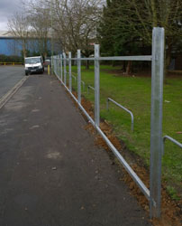Galvanised steel fencing running alongside a footpath